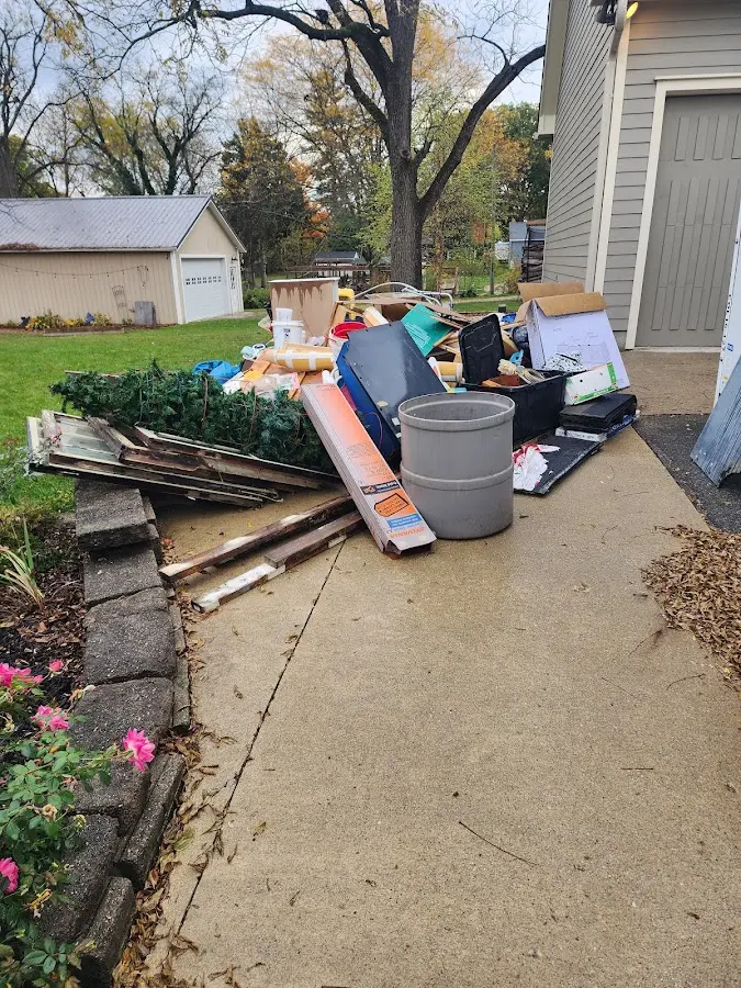 Dumpster being loaded with debris for Estate Cleanout Dumpster Rental in Lakeland North